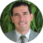 Photo of a smiling middle aged man in a gray suit