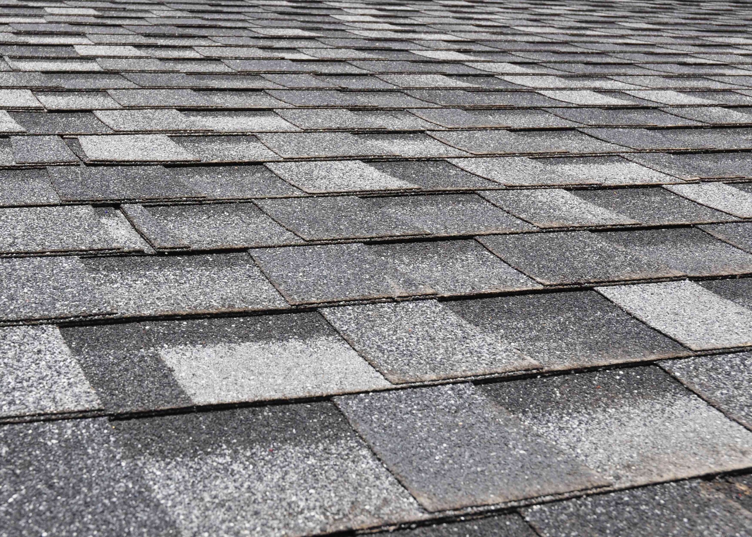 Close up of gray shingle tiles showing some wear and tear
